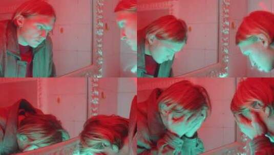 男人在红色灯光的浴室里洗脸高清在线视频素材下载