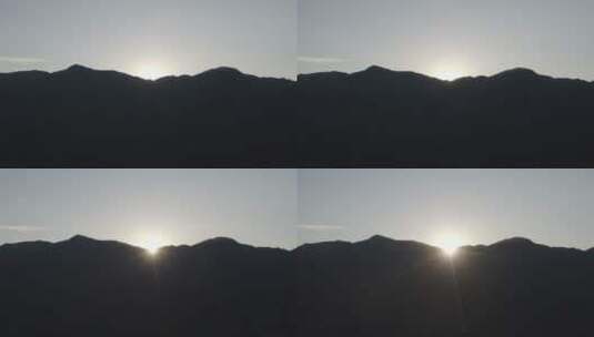 太阳从山后露出航拍日景高清在线视频素材下载