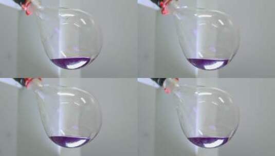 盛着紫色液体的蒸发器在旋转高清在线视频素材下载