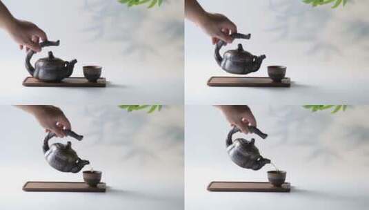 将壶中的茶水倒入杯中高清在线视频素材下载