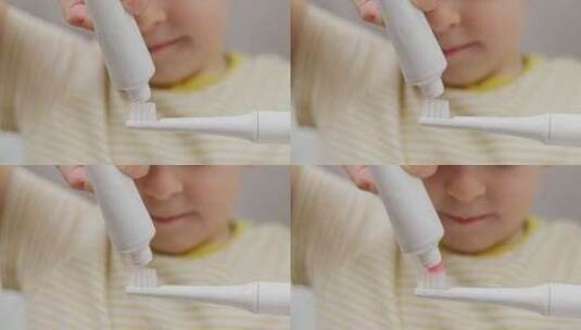 儿童在牙刷上涂抹牙膏高清在线视频素材下载