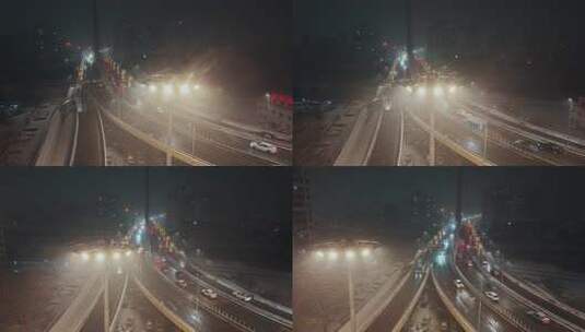 大雪夜景中车来车往的大桥交通景象高清在线视频素材下载