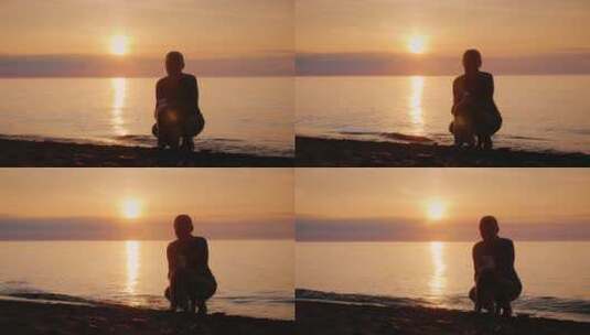 日落时分女人在海边和狗玩耍高清在线视频素材下载