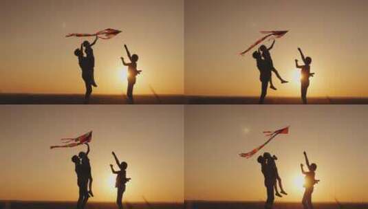 快乐的家庭在日落时玩风筝妈妈爸爸和女儿在一起很开心4K视频高清在线视频素材下载
