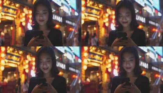 夜晚成都街头年轻女孩看手机上网发消息高清在线视频素材下载