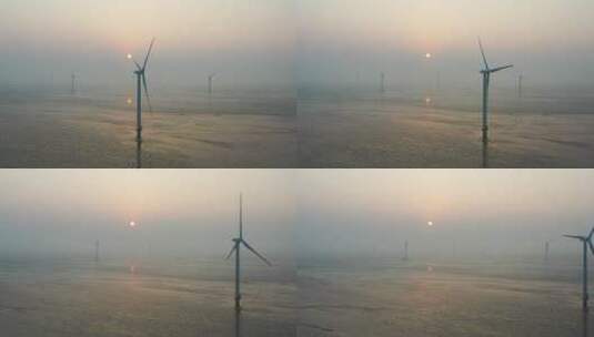如东县滩涂风力发电场在清晨日出时刻的航拍高清在线视频素材下载