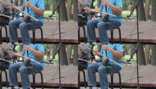 男人在公园里玩二胡高清在线视频素材下载
