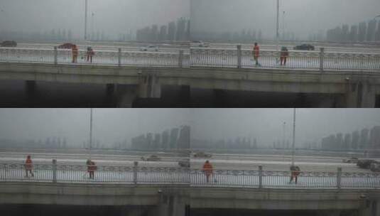 航拍武汉光谷大桥冬天环卫工人铲雪高清在线视频素材下载