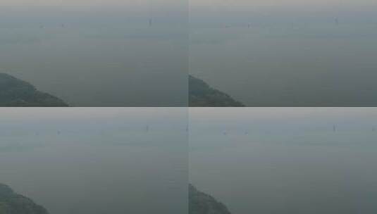 航拍武汉东湖公园清晨大雾水面远处城市高清在线视频素材下载