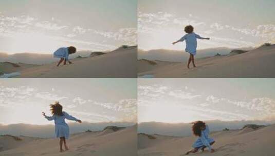 女舞者在沙丘上的夏日日落中投沙表演高清在线视频素材下载