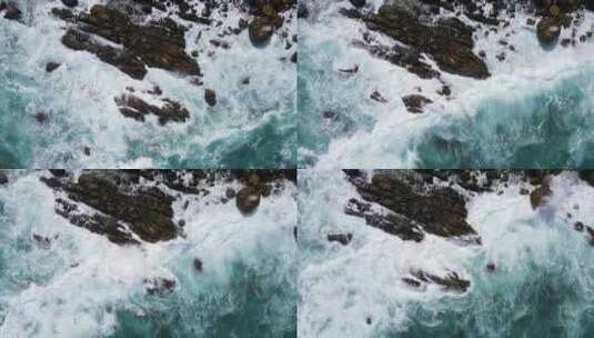 航拍蓝色的海浪拍打礁石慢动作特写高清在线视频素材下载