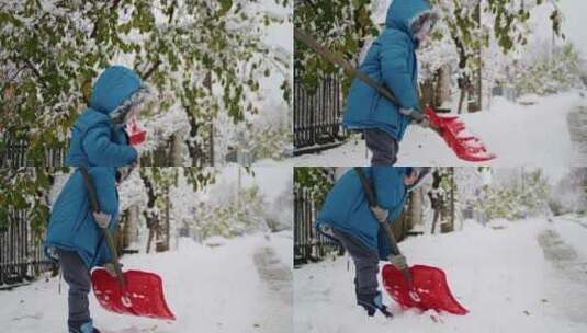 一个孩子在大雪中清理他房子的车道，展现出高清在线视频素材下载