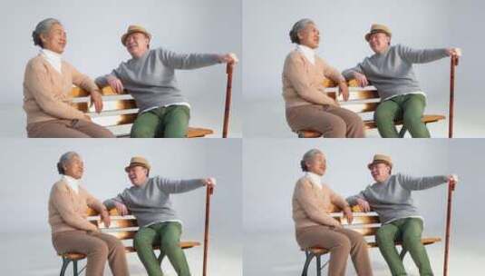 坐在长椅上聊天的老年夫妇高清在线视频素材下载