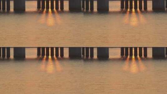 海水桥墩夕阳光束高清在线视频素材下载