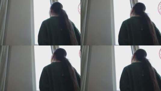 梳马尾辫的女孩眺望窗外高清在线视频素材下载