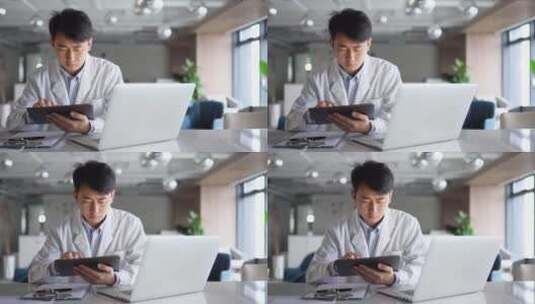 年轻医学科研人员办公室使用平板笔记本电脑高清在线视频素材下载