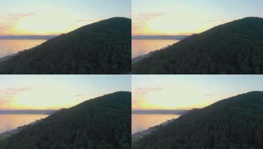 无人机飞越湖岸的森林高清在线视频素材下载