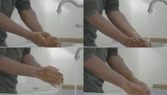 男人在流动的水龙头下用肥皂水洗手高清在线视频素材下载
