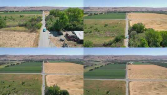 无人机拍摄的浅蓝色经典芥末在加州乡村公路上行驶的镜头高清在线视频素材下载