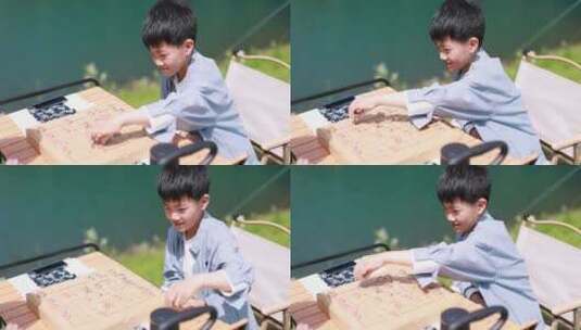 在湖边下棋的中国男孩 升格慢镜高清在线视频素材下载