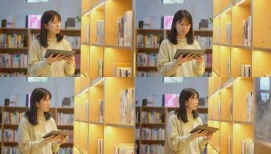 年轻女子在图书馆使用平板电脑找书高清在线视频素材下载