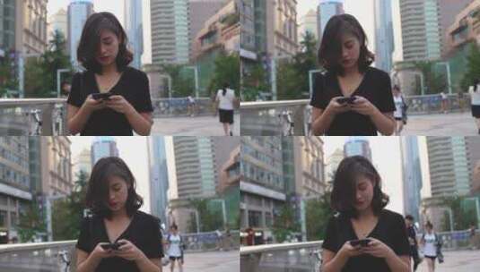 年轻美女在城市街头看手机浏览社交媒体高清在线视频素材下载