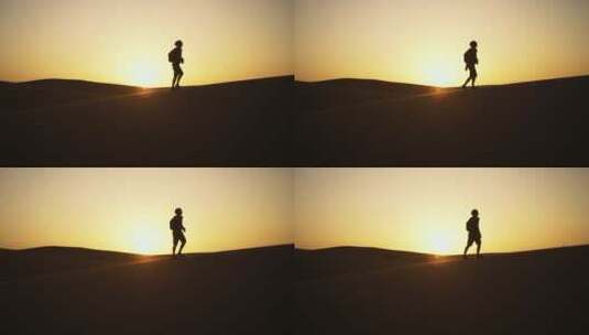 游客在黄昏的沙漠上行走高清在线视频素材下载