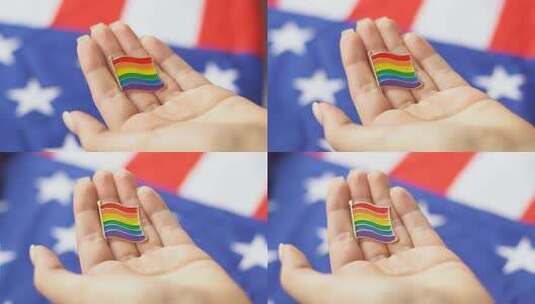 年轻女子手里拿着同性恋、双性恋和变性者的图标。背景是美国国旗。高清在线视频素材下载