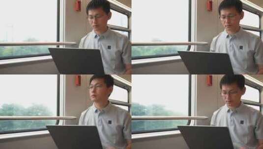 中年男子在火车上使用笔记本电脑工作高清在线视频素材下载