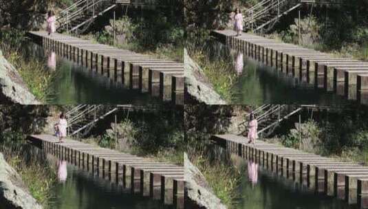 穿裙子户外过河的可爱女孩高清在线视频素材下载