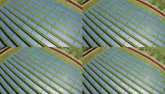 一个大型太阳能农场，绿色草地上有一排排太高清在线视频素材下载