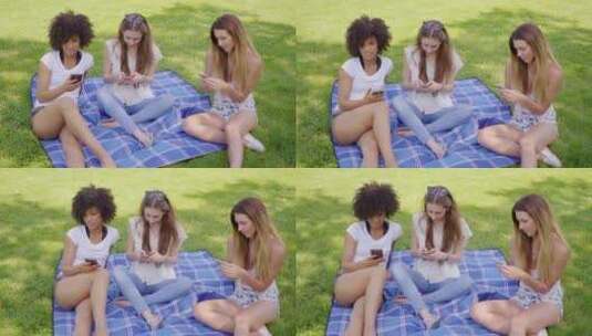 朋友在野餐时玩手机高清在线视频素材下载