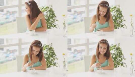 年轻女子坐在桌旁微笑高清在线视频素材下载