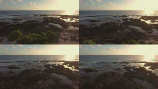 航拍夕阳下的海边礁石海浪天际线高清在线视频素材下载