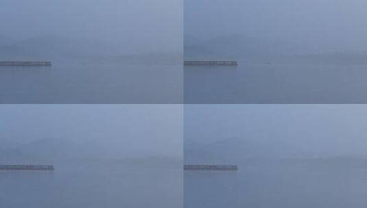 杭州西湖清晨浓雾中行驶的小船高清在线视频素材下载