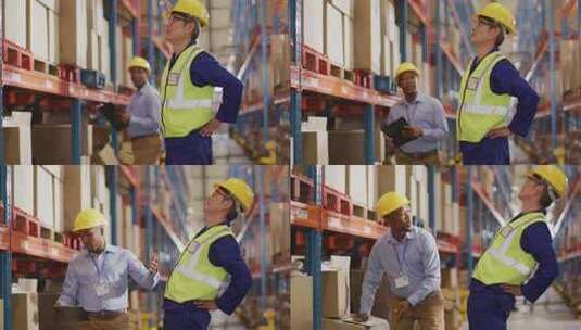 不同的男性工人戴着头盔，在仓库里抚摸背部高清在线视频素材下载