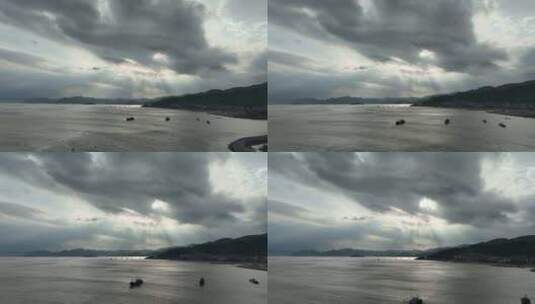 大海边阳光穿透乌云照在海面丁达尔光上帝光高清在线视频素材下载
