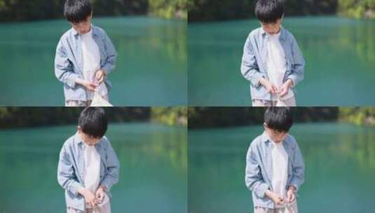 中国小男孩正在湖边扎帐篷高清在线视频素材下载
