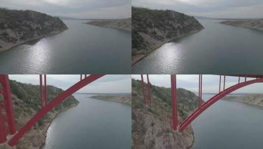 航拍河流上红色钢桥高清在线视频素材下载