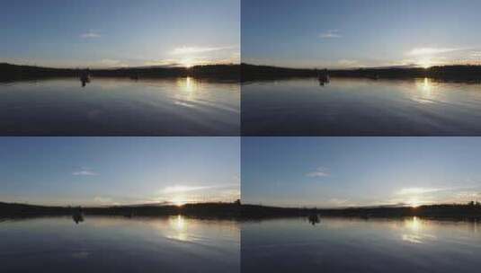 日落时漂浮在湖面上的船高清在线视频素材下载
