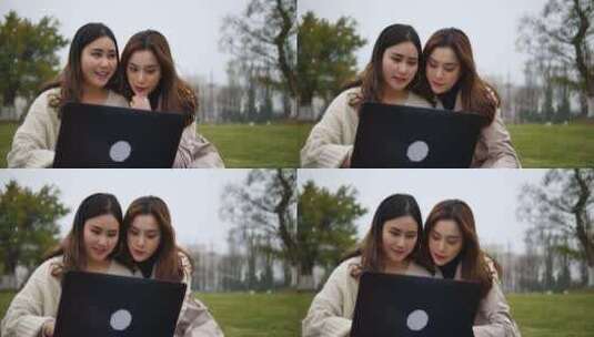 两位年轻美女大学生在校园公园看电脑学习高清在线视频素材下载