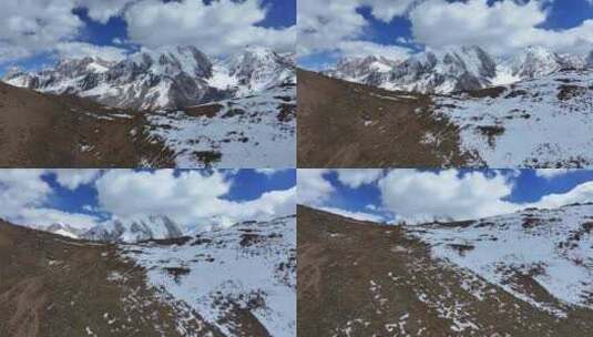 航拍垭口观看贡嘎山区雪山群峰的徒步旅行者高清在线视频素材下载