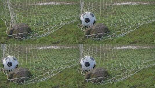 足球被踢进用石头按住的球门网里高清在线视频素材下载