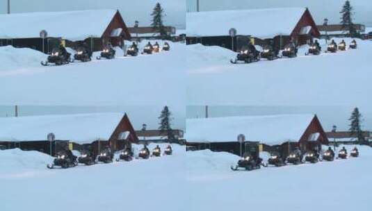 小镇上在雪地上驾驶雪地摩托的人高清在线视频素材下载