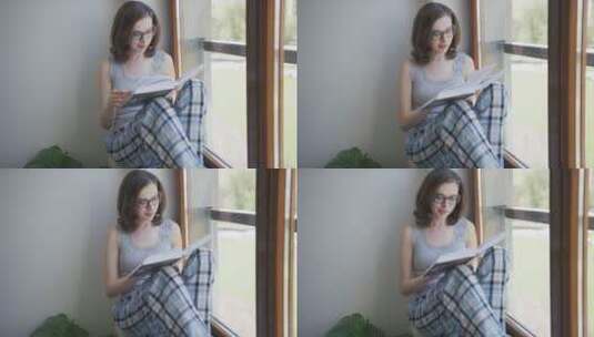 女孩坐在窗台上看书高清在线视频素材下载