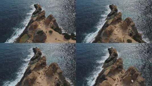 航拍从岩石悬崖到海面浪花高清在线视频素材下载