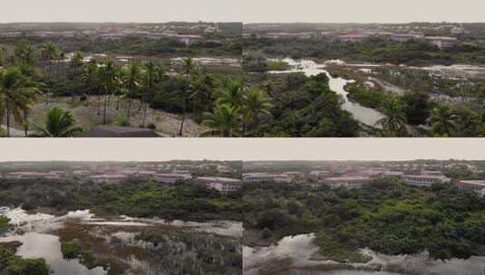 无人机飞越树木沼泽和房屋高清在线视频素材下载