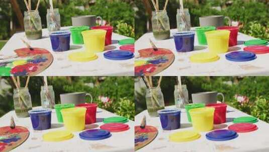 花园里桌子上彩色油漆和绘画设备的特写高清在线视频素材下载