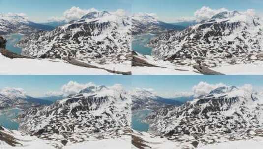 空中：山顶徒步旅行者，滑雪旅游登山雪山，阿尔卑斯山全景高清在线视频素材下载