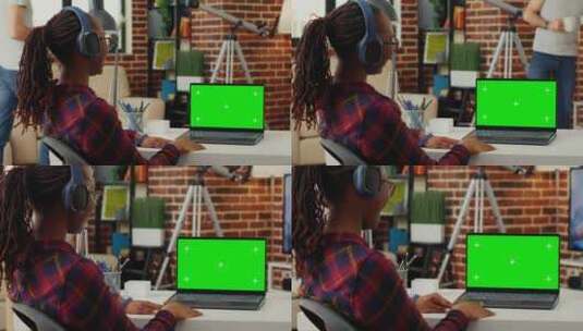戴耳机使用绿屏笔记本电脑的女经理高清在线视频素材下载